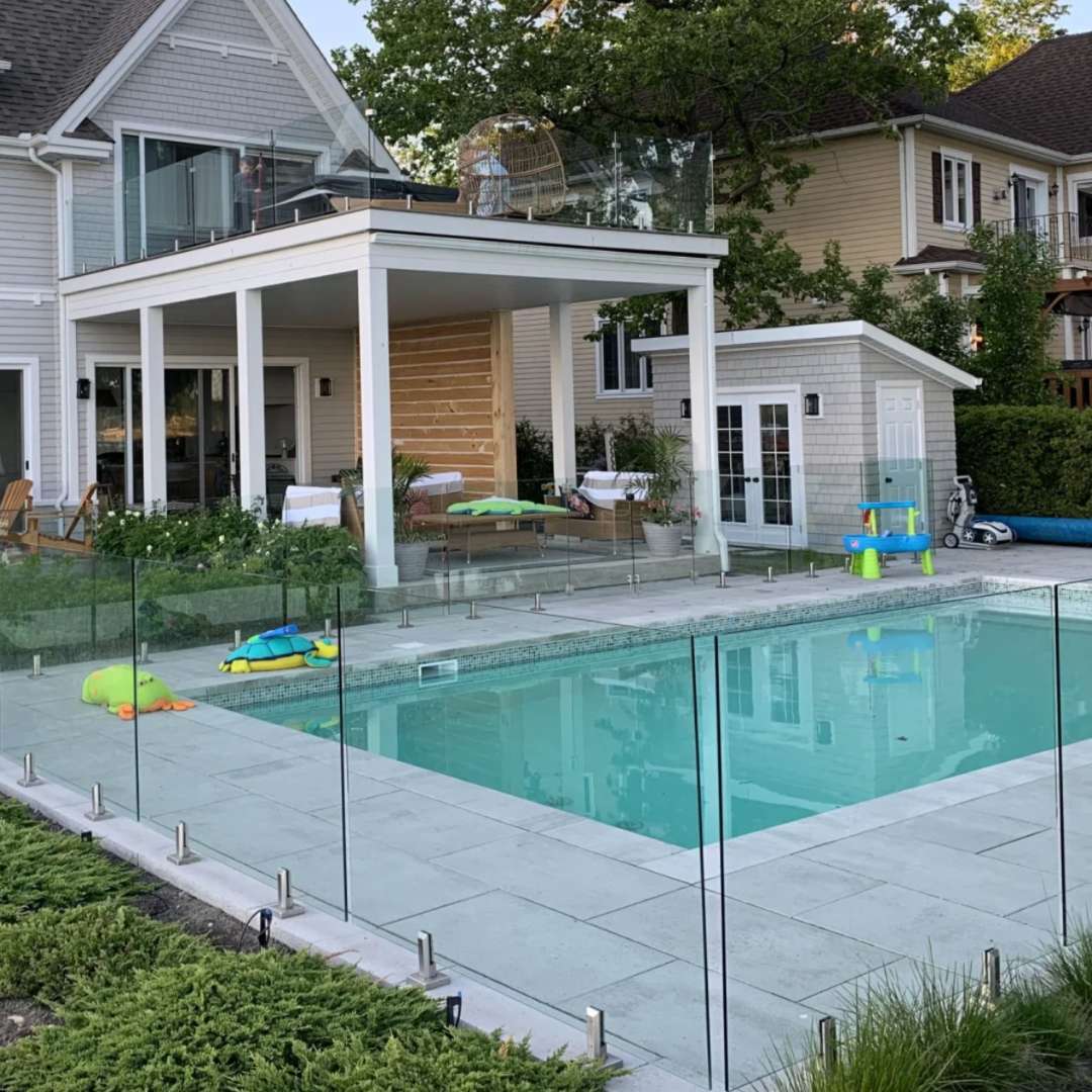 Glass railing surrounding a poolside deck