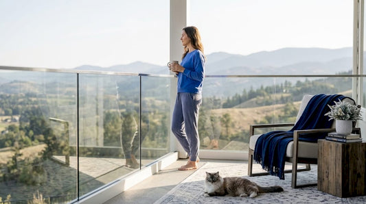Woman enjoying view through glass railing
