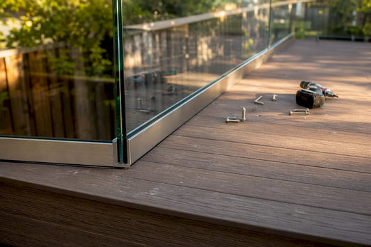 Partial frameless glass railing on composite deck corner