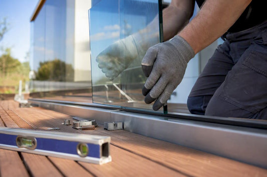 Hands installing balcony glass panel