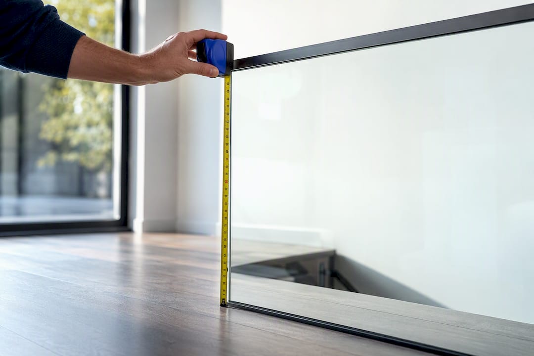 Parent measuring glass railing height