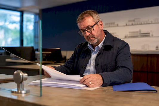 Building official reviewing glass railing permit plans