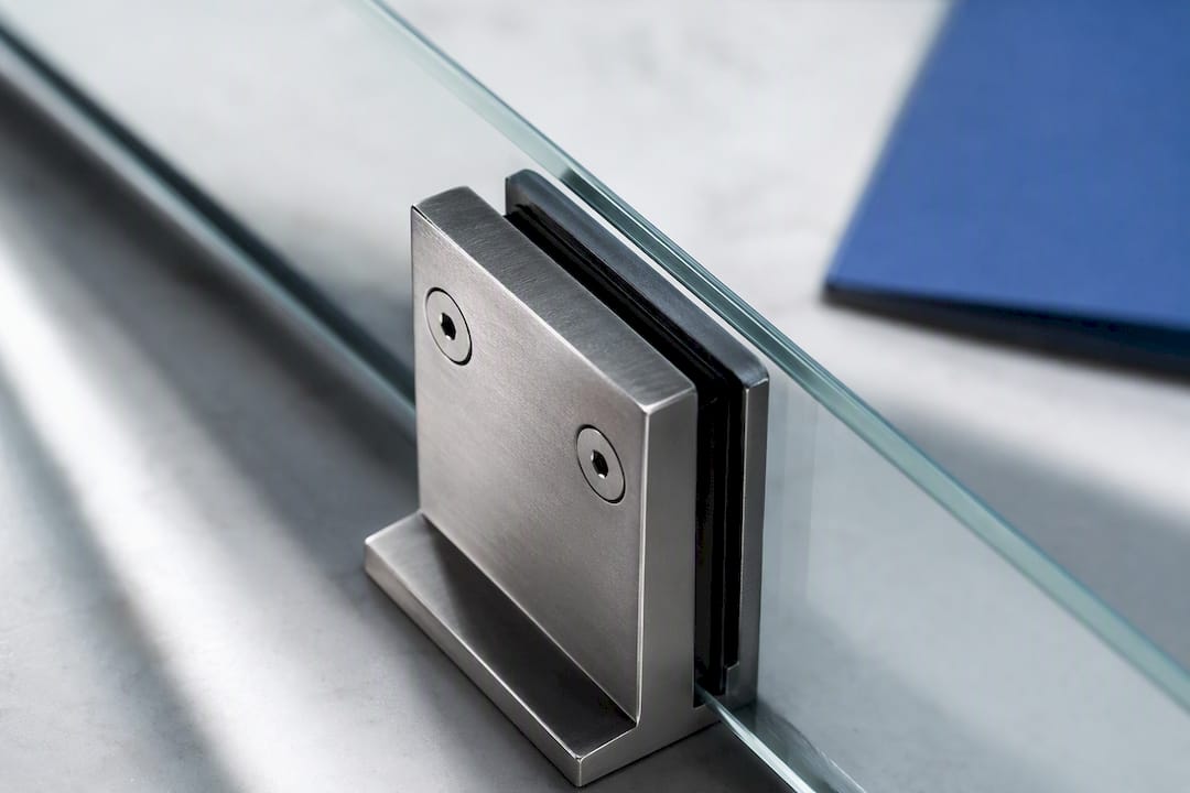 Close-up of clamp gripping glass edge