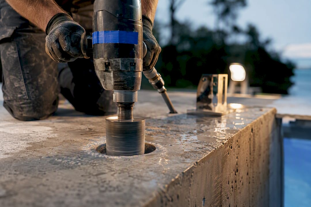 Core drill creating concrete post opening