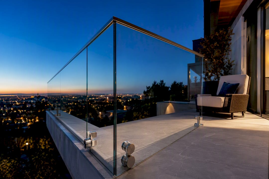 Glass balcony edge overlooking a modern home