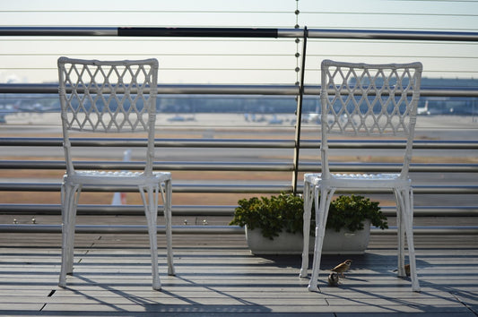 a couple of white chairs sitting next to each other - Photo by haru toyko on Unsplash