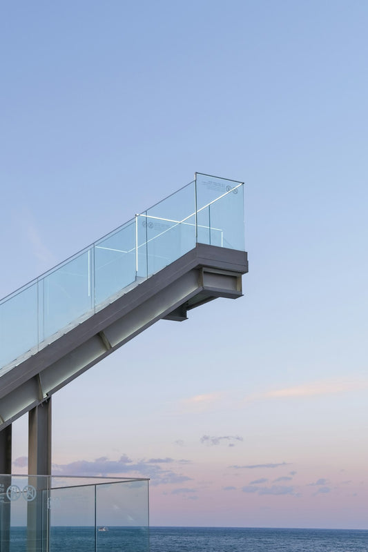 gray metal bridge under blue sky during daytime - Photo by Wesley Shen on Unsplash