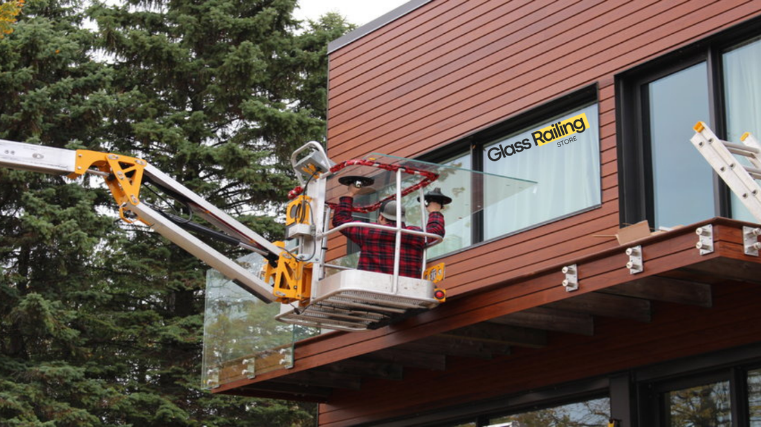 construction worker installing a glass railing system on a balcony