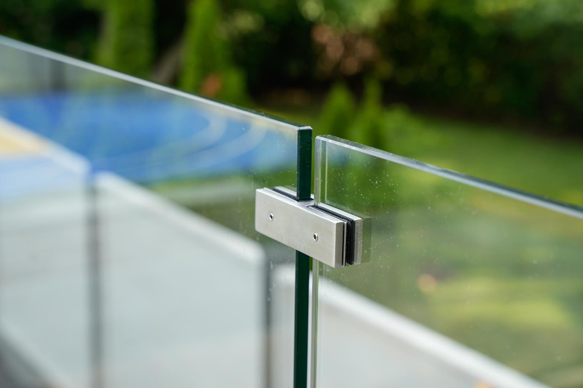 Two tempered glass panels joined inline by a brushed stainless connector