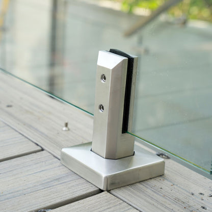 Close up of brushed stainless spigot base plate holding a 12mm tempered glass panel