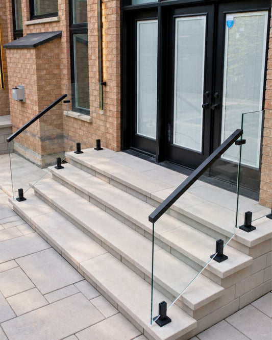 Frameless glass stair railing with no posts or top rail blocking the view