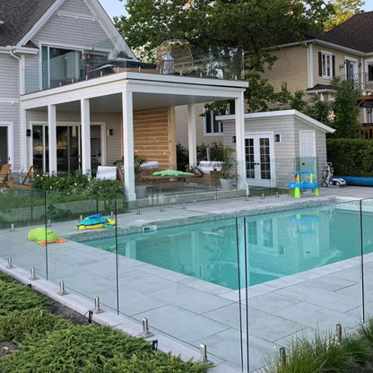 Glass railing surrounding a poolside deck
