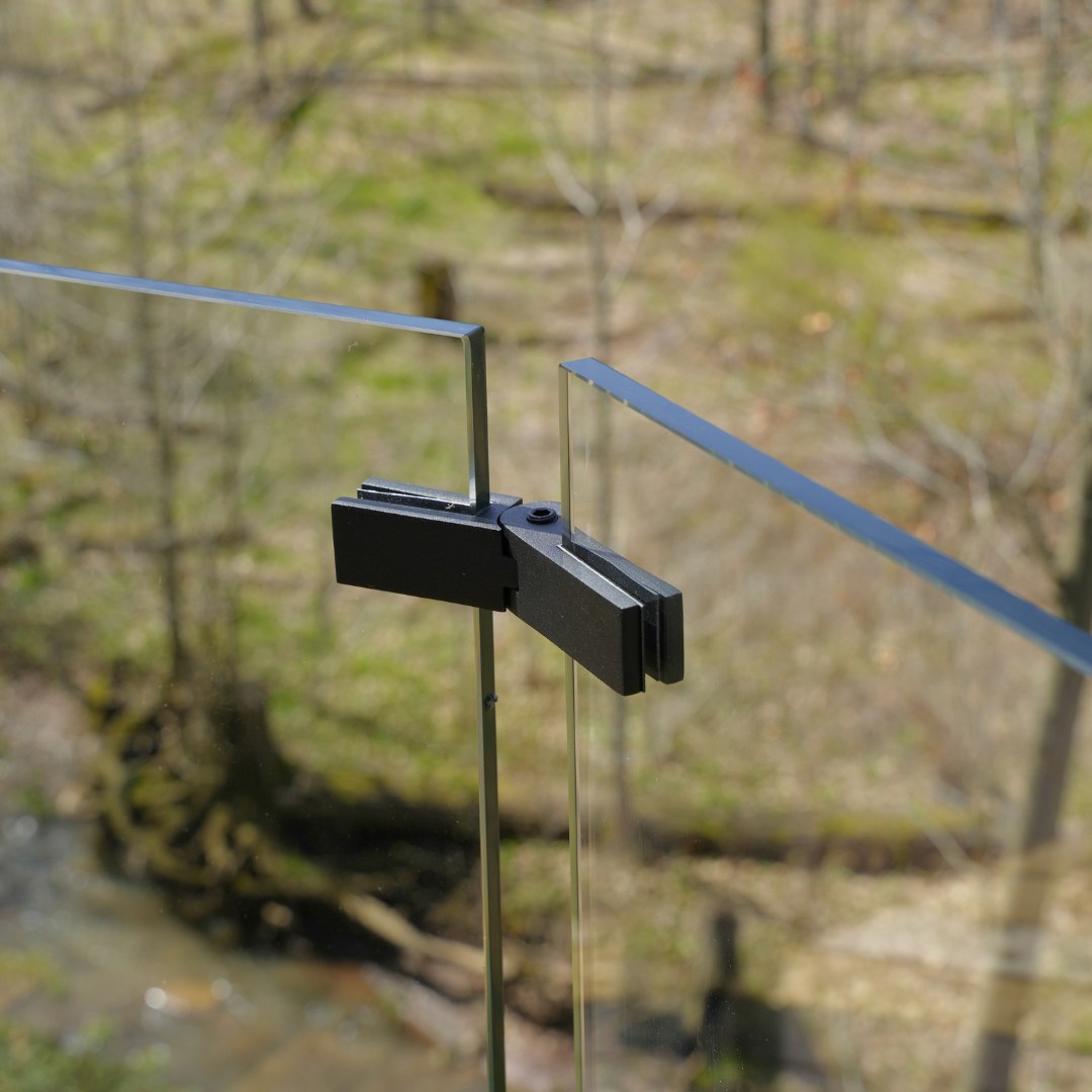Adjustable glass railing connector mounted on a deck