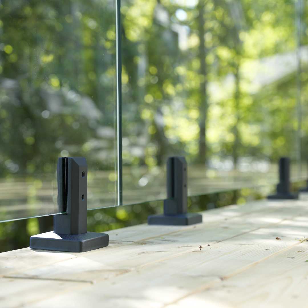 Matte Black glass railing spigot mounted on a deck