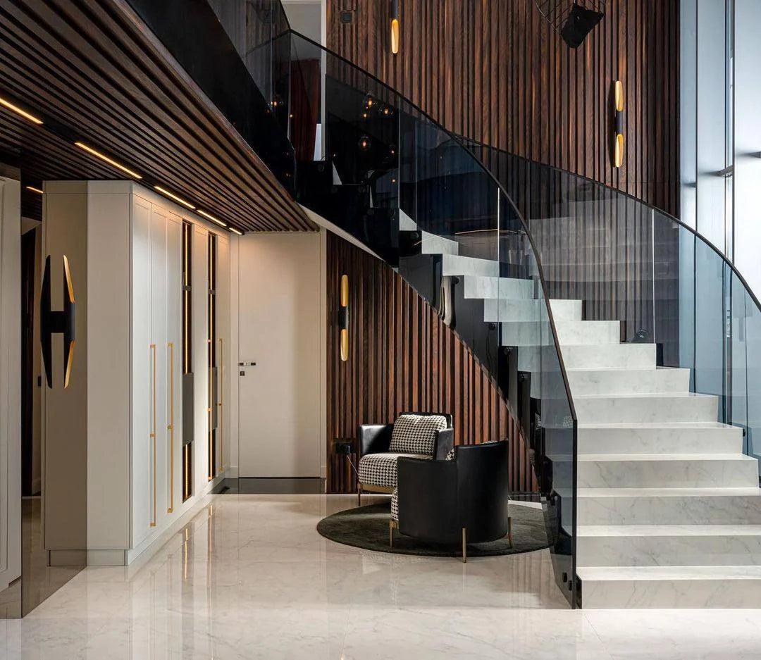 Modern staircase with glass railings in a stylish interior setting.